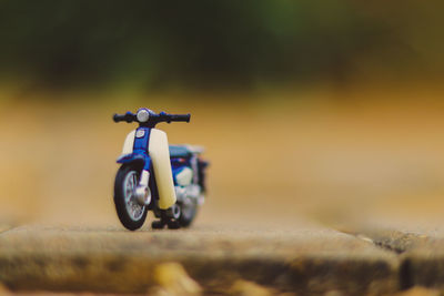 Close-up of toy motorcycle on road