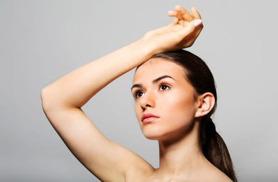 Portrait of young woman against white background