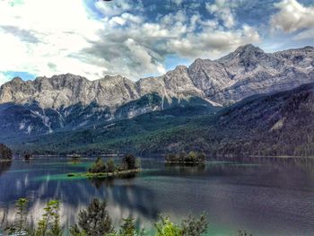 Scenic view of lake and mountains against sky