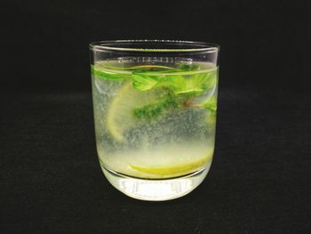 Close-up of beer glass on table against black background