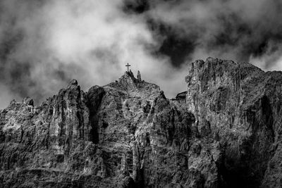 Low angle view of rocky mountains against sky