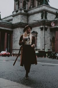 Woman standing on street in city