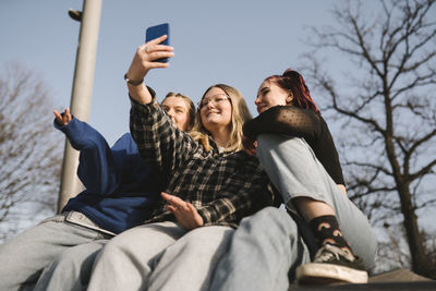 Teenage girls taking selfie with smart phone