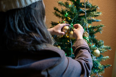 Midsection of woman holding christmas tree