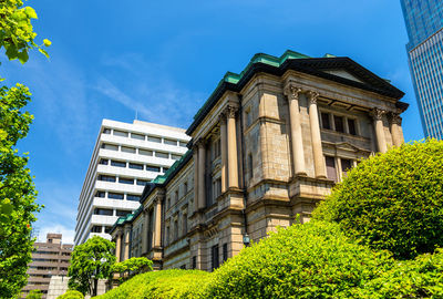 Low angle view of buildings against blue sky