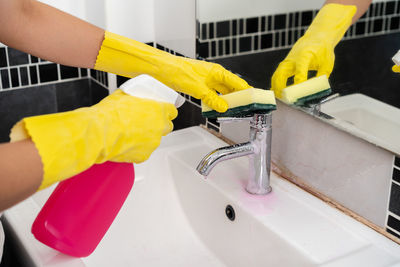 Midsection of woman in bathroom at home