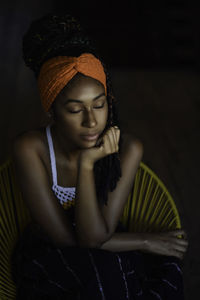 Interior portrait of young latin woman with eyes closed