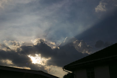 Low angle view of silhouette building against sky