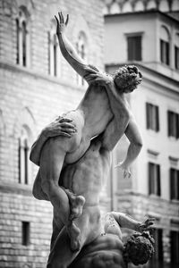 Low angle view of statue against building 