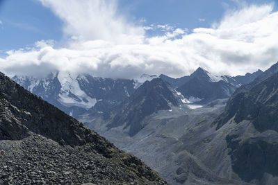 Scenic view of mountains against cloudy sky