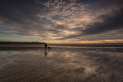 Dog walk on old hunstanton beach at sunset