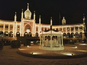 Illuminated temple against sky at night