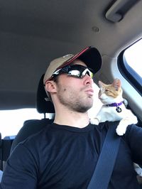 Young man and woman sitting in car