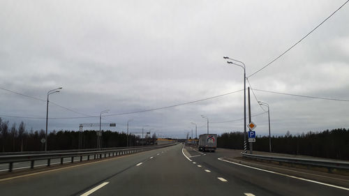 Cars on road against sky