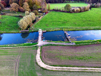 Aerial photo of a pedestrian bridge and weir in the berkel river in gelderland, netherlands.