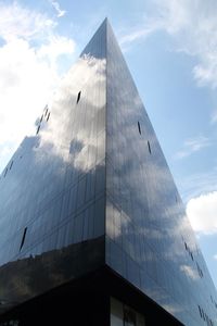 Low angle view of buildings against cloudy sky