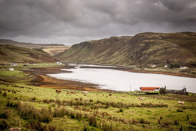 Scenic view of lake against cloudy sky