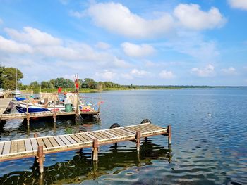 Pier over lake against sky