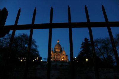 Low angle view of illuminated building against sky at dusk