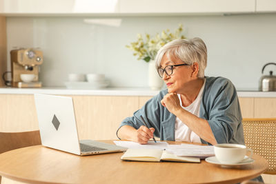 Young woman using laptop at home