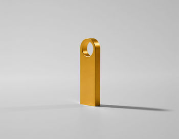 Close-up of cross on table against white background