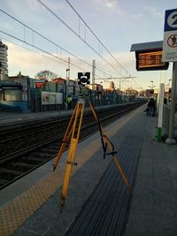 Railroad tracks in city against sky