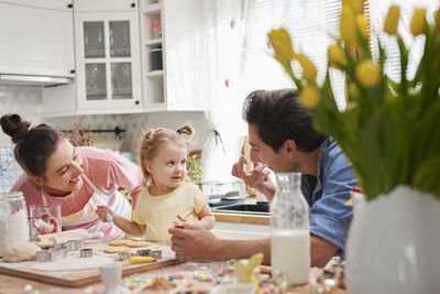 Family preparing food in kitchen