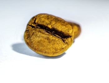 Close-up of bread on table against white background