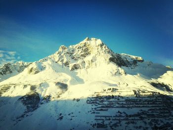 Scenic view of snow covered mountains against sky