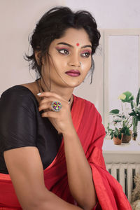 Portrait of beautiful young woman sitting at home