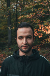 Portrait of young man against trees during autumn