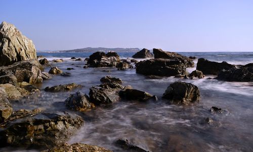 Scenic view of sea against clear blue sky
