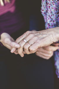 Cropped image of grandmother and granddaughter holding hands