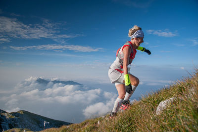 Full length of man standing on mountain against sky