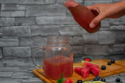 Cropped hand of man preparing food on table