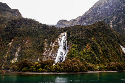 Scenic view of waterfall against sky