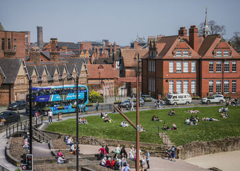 High angle view of people in city against buildings, chester 