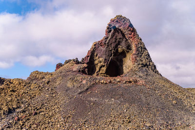 Low angle view of rock formations against sky