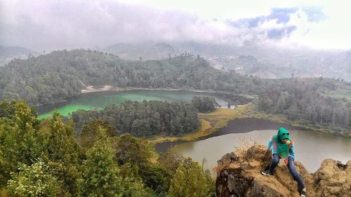 Scenic view of river and mountains against sky