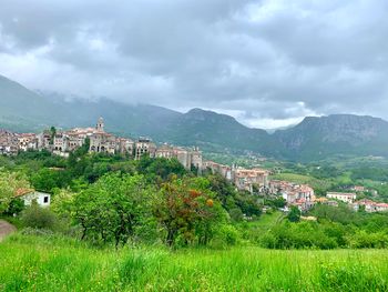 Townscape by mountains against sky