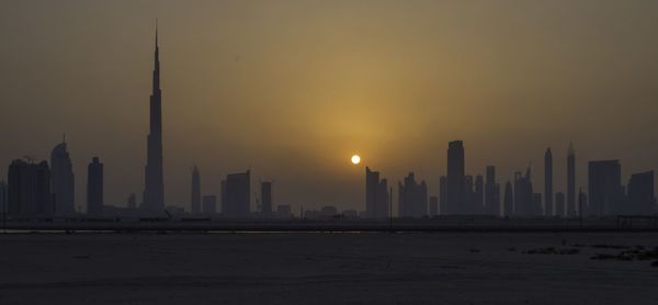 City at waterfront during sunset