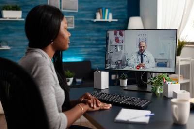 Businesswoman talking with doctor on video call
