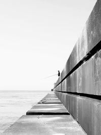 View of pier on sea against clear sky