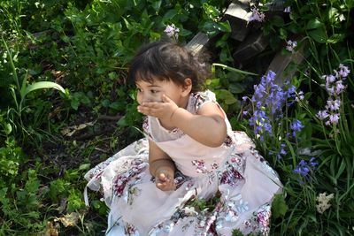 High angle view of cute baby girl on field