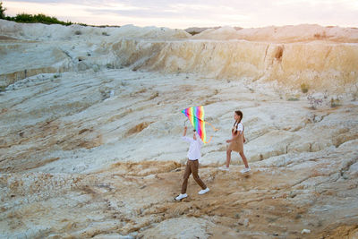 Children carry a kite in their hands, tired return home from a walk.