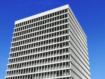 Low angle view of modern building against clear blue sky