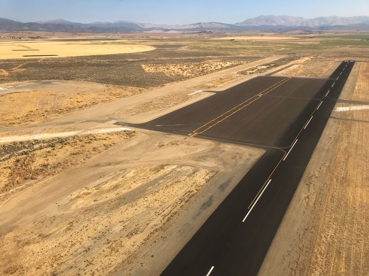 AERIAL VIEW OF ROAD PASSING THROUGH LANDSCAPE