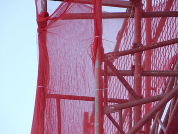 Low angle view of red construction site against sky