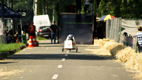 Rear view of woman walking on road in city