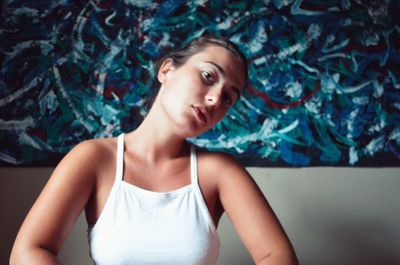 Portrait of beautiful young woman sitting at home